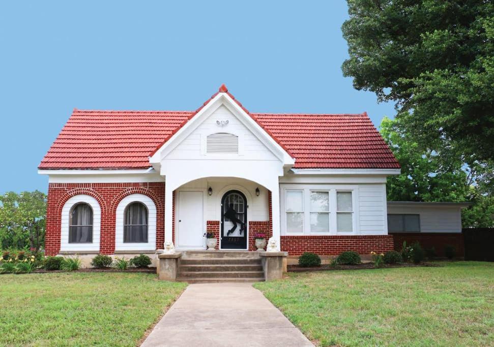 a white and red house with a red roof at The Elvis House in Waco