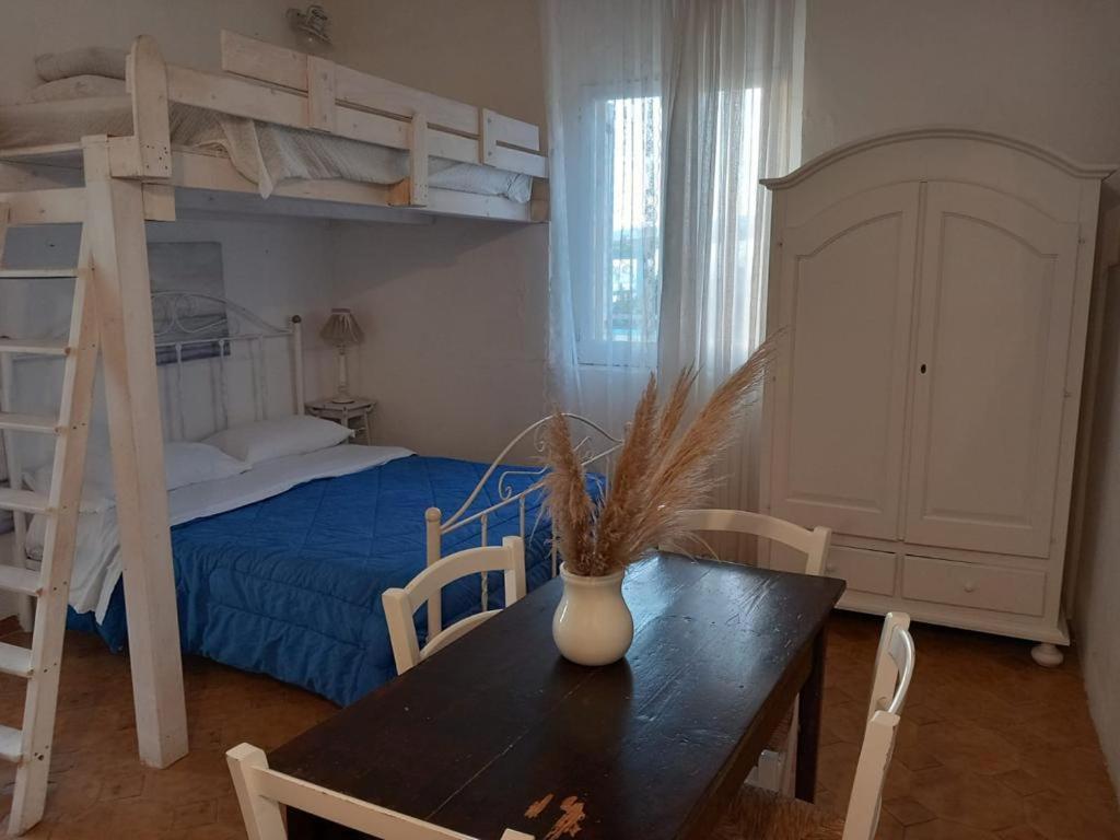 a room with a table and a bunk bed at Villa Vathi in Granelli