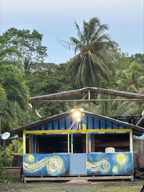 a blue and yellow bus parked in front of a building at Iguana Azul Pacific Paradise in Buenaventura