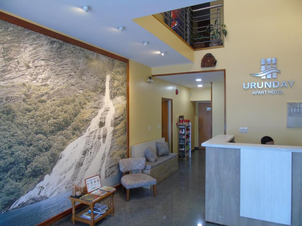 a lobby with a large painting on the wall at Urunday Apart Hotel in Posadas