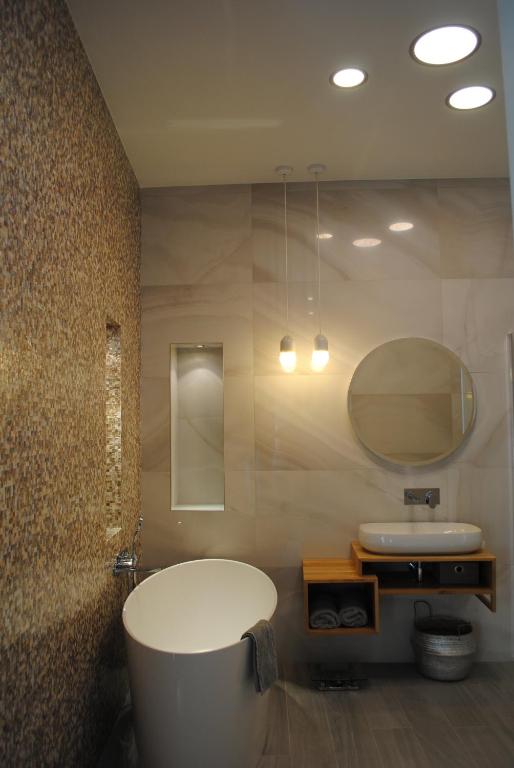 a bathroom with a white tub and a sink at Les Suites Massena in Nice