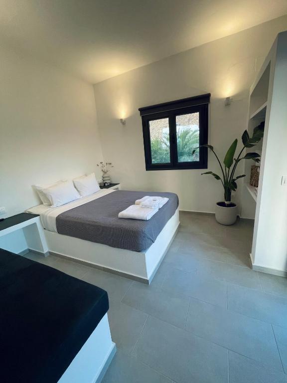 a bedroom with a large bed and a window at Vie rêvée luxury suites in Ganema