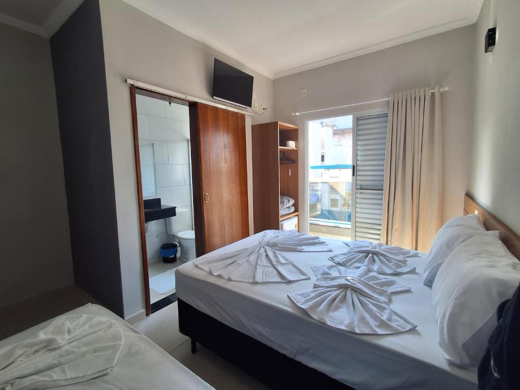 Postel nebo postele na pokoji v ubytování Hotel Supremo