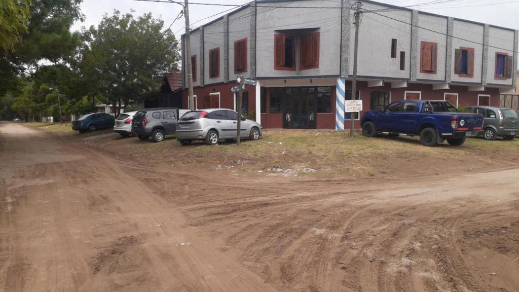 un groupe de voitures garées devant un bâtiment dans l'établissement Refugio de mar, à Costa Azul