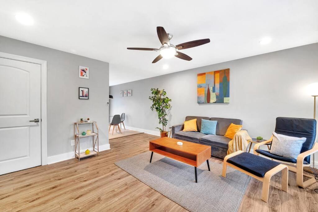 a living room with a couch and a ceiling fan at Homey 2BR Condo—King Bed—Lovely Location & Parking in Charlotte