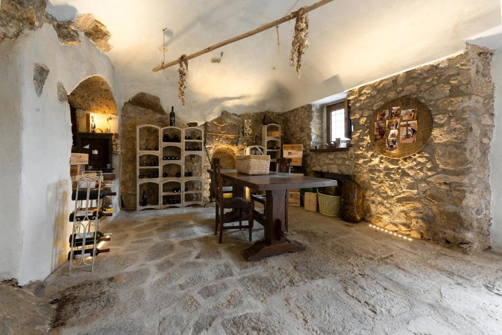 a room with a table and a stone wall at Agriturismo Sant'Alfonso in Furore