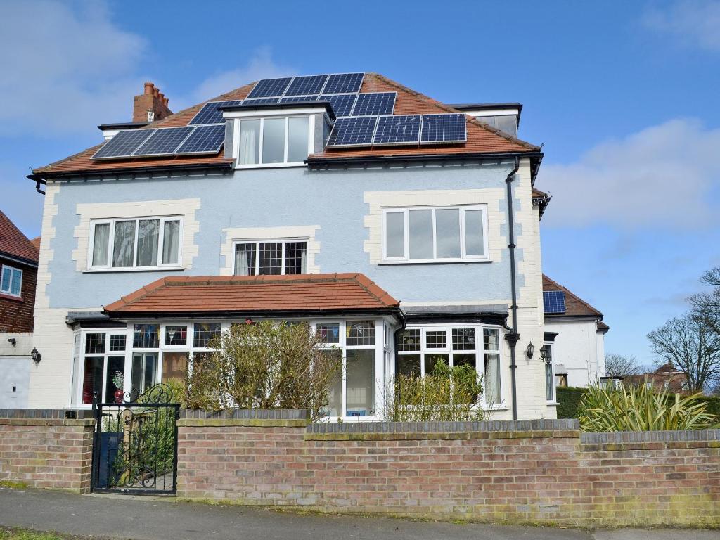 a house with solar panels on the roof at Ryndle Corner in Scarborough