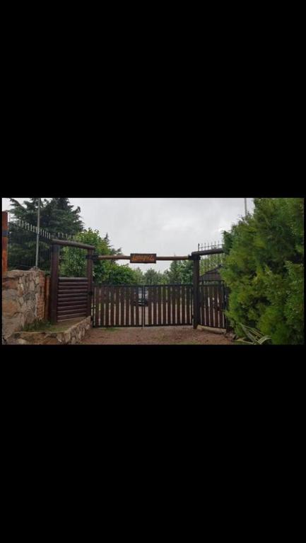 a wooden fence with a gate in a yard at LA NEGRITA in Ciudad Lujan de Cuyo