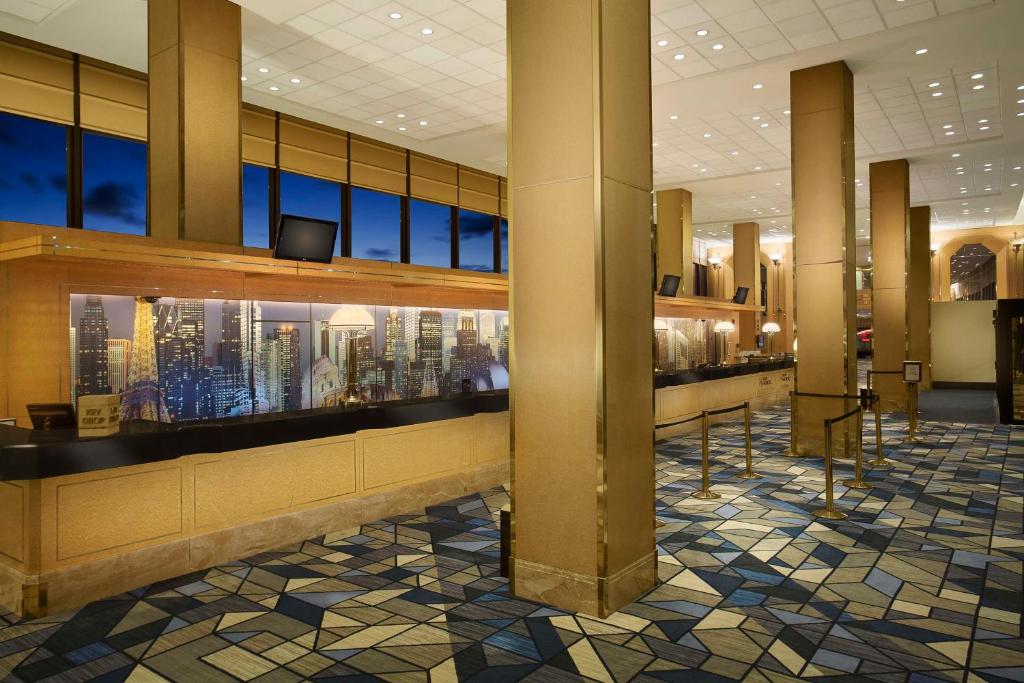 a lobby of a building with a view of a city at Hilton Chicago O'Hare Airport in Rosemont