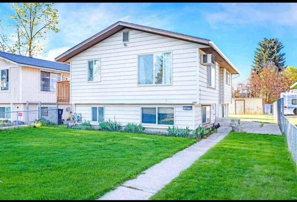 a large white house with a green yard at Anthony's Home in Spokane