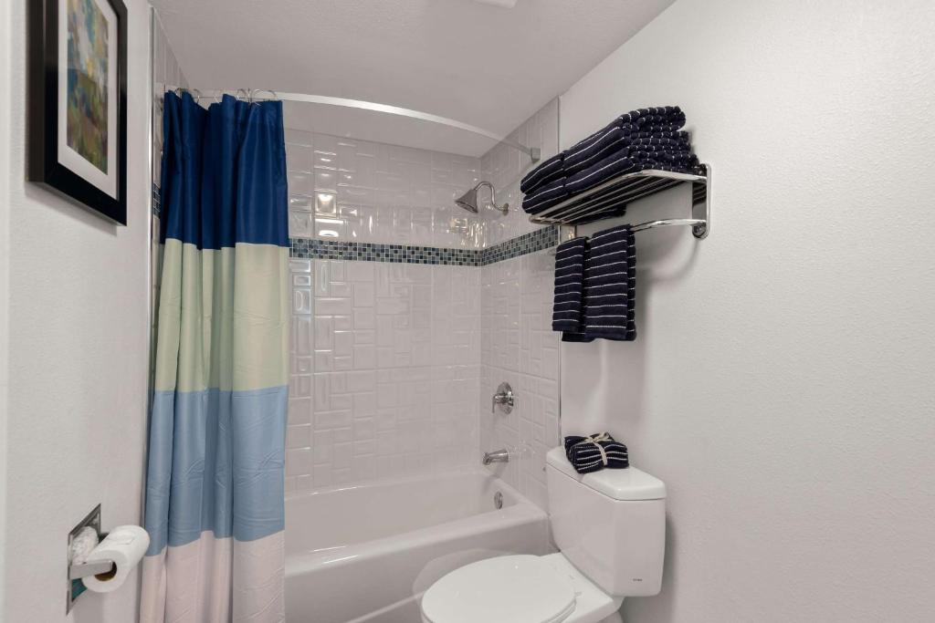 a bathroom with a toilet and a shower and a tub at Best Western Plus Manhattan Beach Hotel in Manhattan Beach