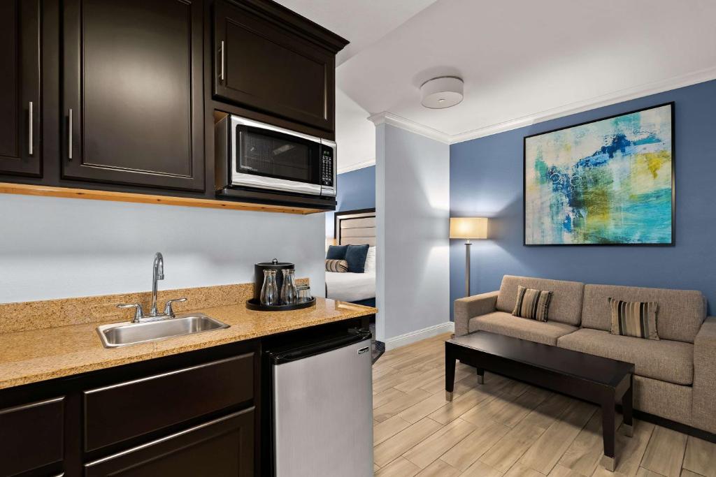 a kitchen with a sink and a couch in a room at Best Western Plus Manhattan Beach Hotel in Manhattan Beach