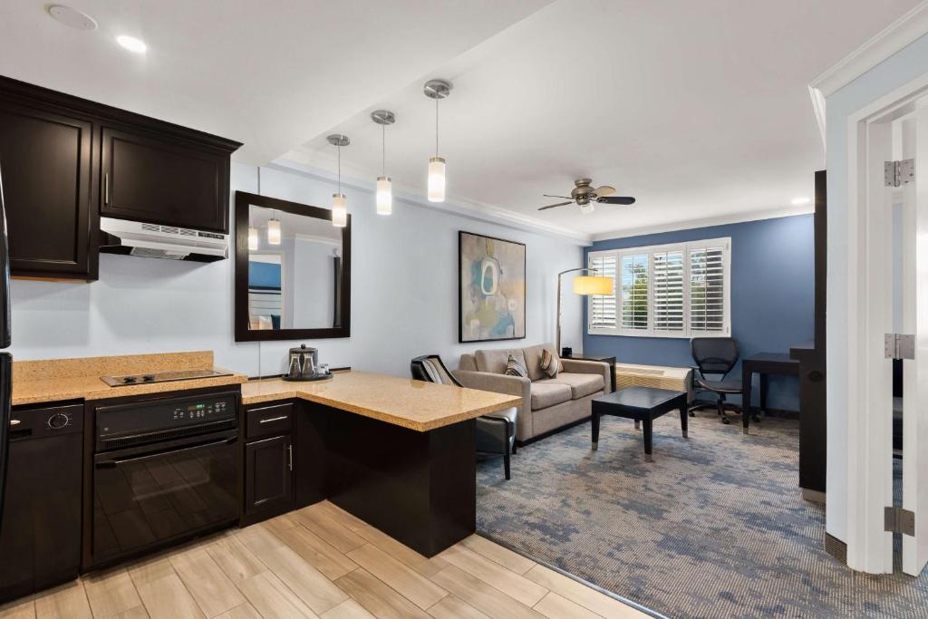 a kitchen and living room with a couch and a table at Best Western Plus Manhattan Beach Hotel in Manhattan Beach