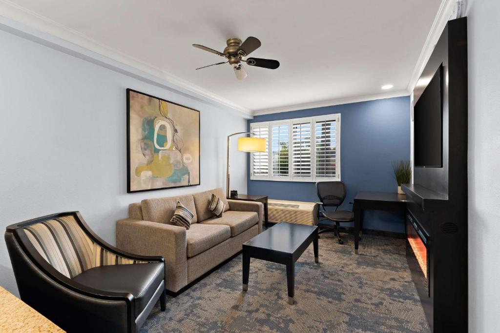 a living room with a couch and a table at Best Western Plus Manhattan Beach Hotel in Manhattan Beach