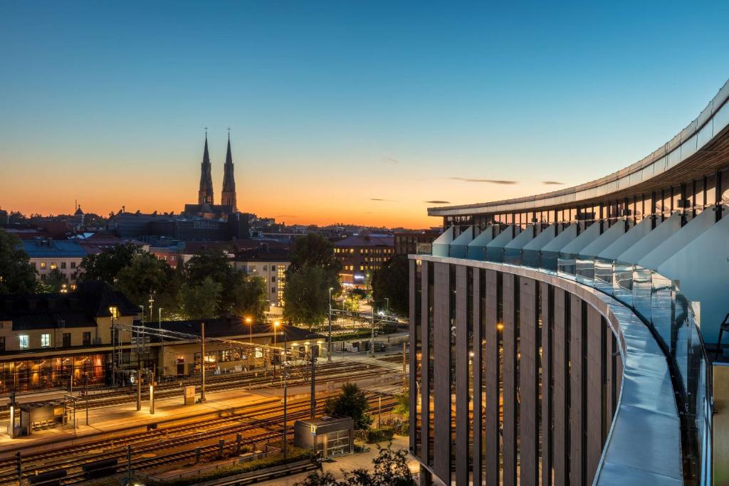 a view of a city at night with a building at Radisson Blu Hotel Uppsala in Uppsala
