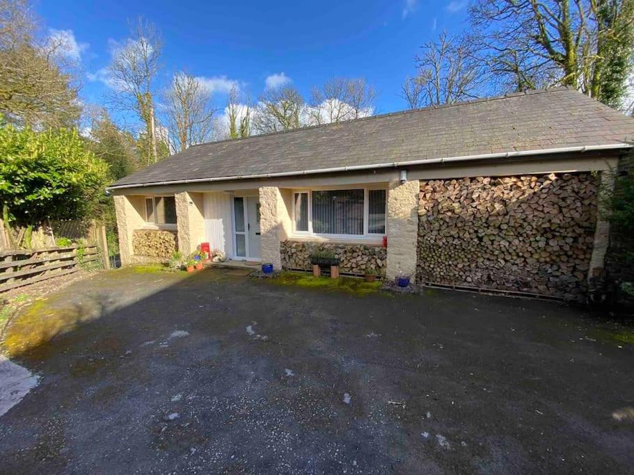 a brick house with a driveway in front of it at Beautiful renovated former coach house in Llandeilo