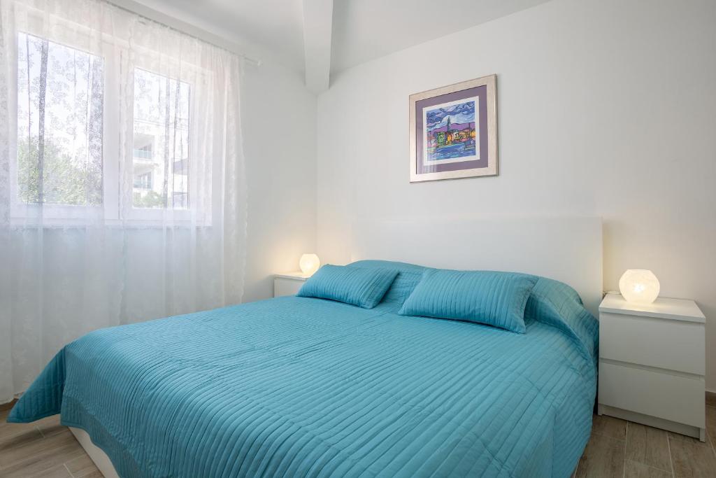 Postel nebo postele na pokoji v ubytování Apartments Oleandar