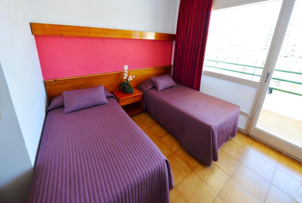 Postel nebo postele na pokoji v ubytování Hostal Magnolia