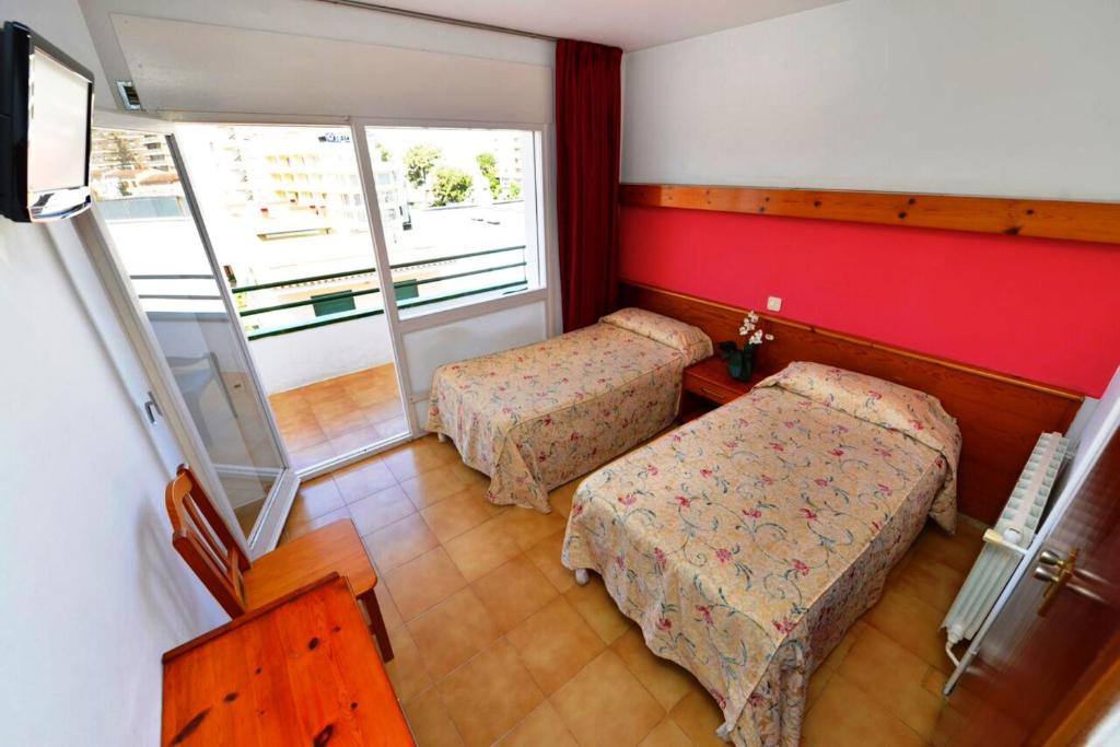 Postel nebo postele na pokoji v ubytování Hostal Magnolia