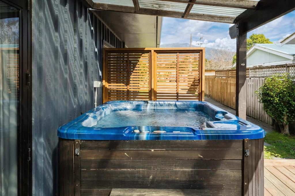a hot tub in the backyard of a house at River Retreat, spa, pets, Wi-Fi in Turangi