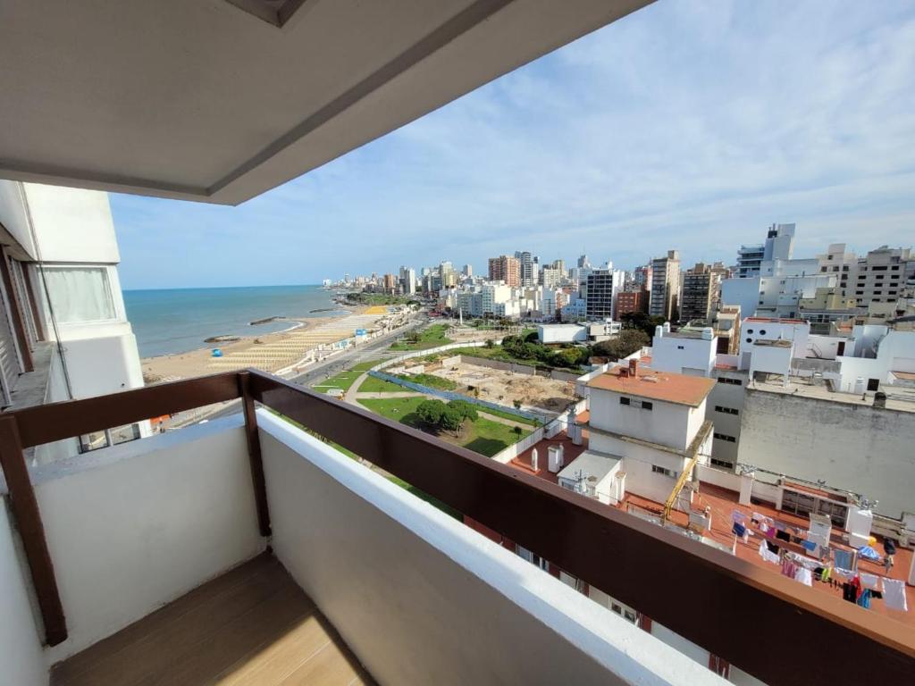 a balcony with a view of the beach and buildings at Nuevo estudio al mar con cochera in Mar del Plata