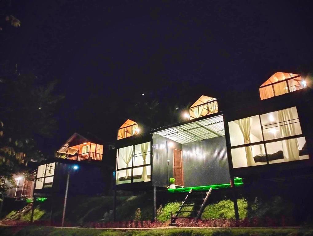 a row of houses lit up at night at Father's Garden Inthanon in Ban Na Yang