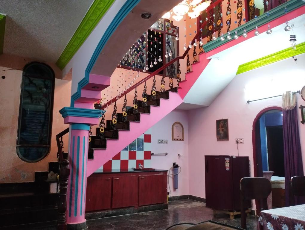 a staircase in a restaurant with colorful walls at Joe Niwas villa 3bhk in Puducherry