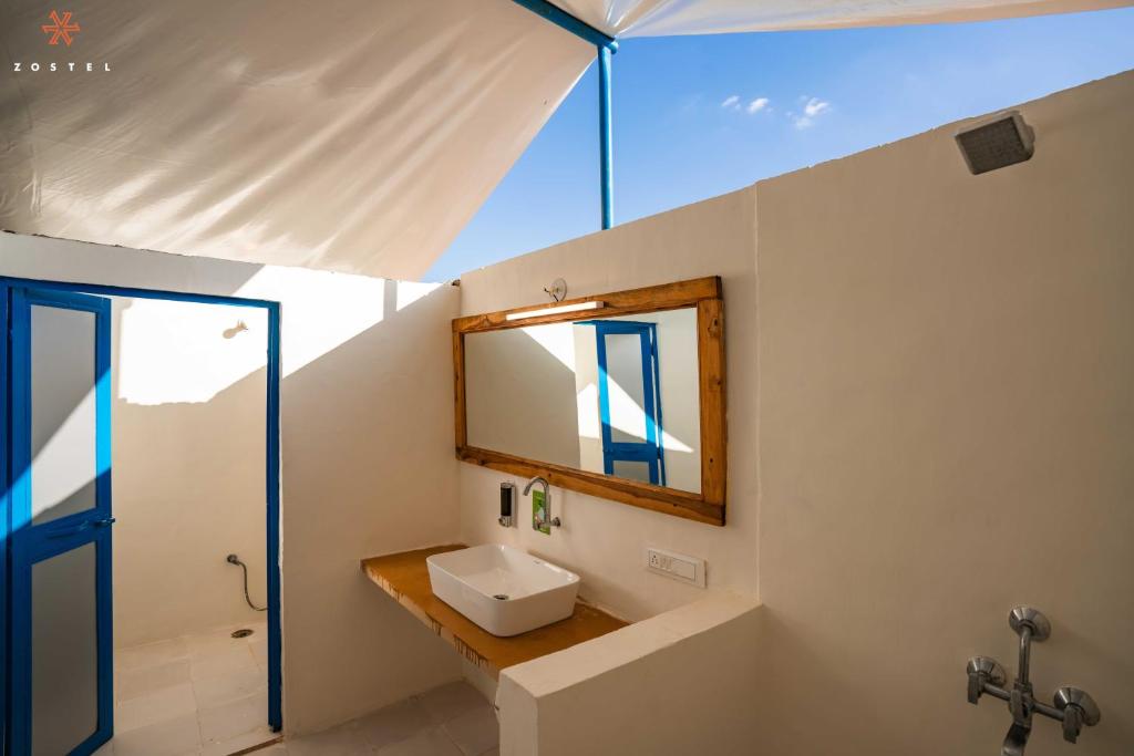 a bathroom with a sink and a mirror at Zostel Sam Desert (Jaisalmer) in Sām