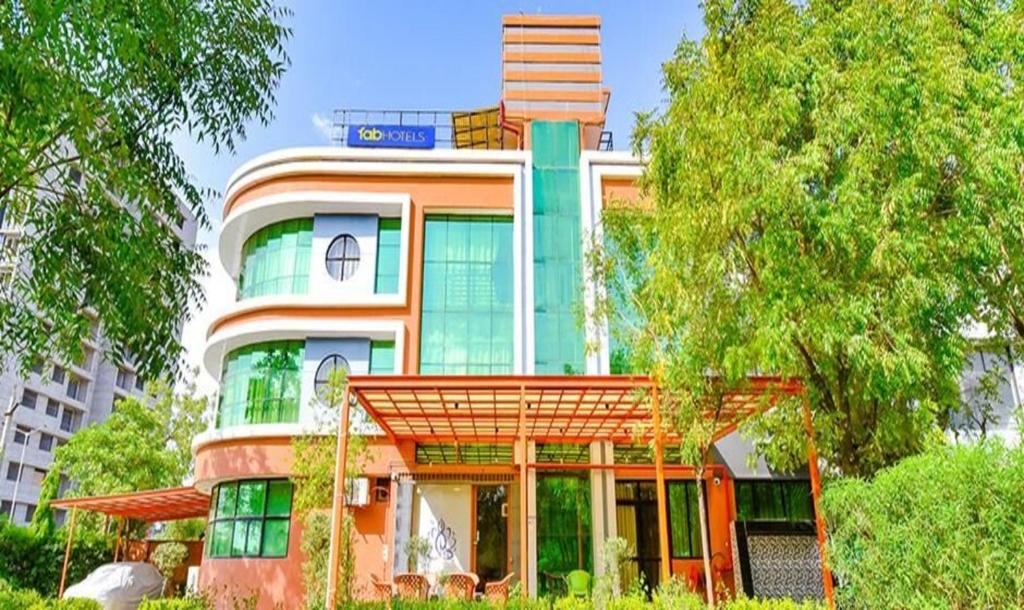 a large building with a sign on top of it at FabHotel Siddharth Corporate in Gandhinagar