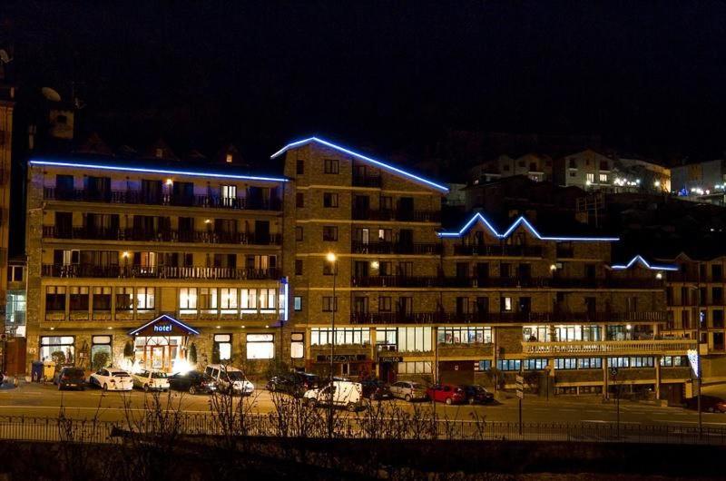 a large building at night with cars parked in a parking lot at HOTEL VICTORIA in Arinsal
