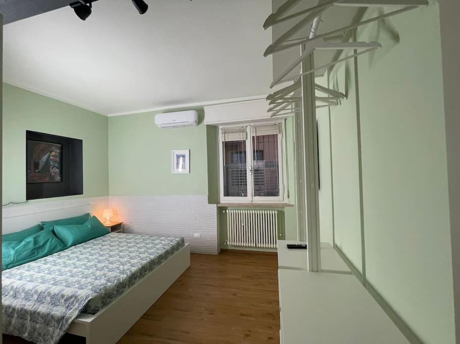 a bedroom with a bed in a room with green walls at Cairoli Apartment in Ravenna