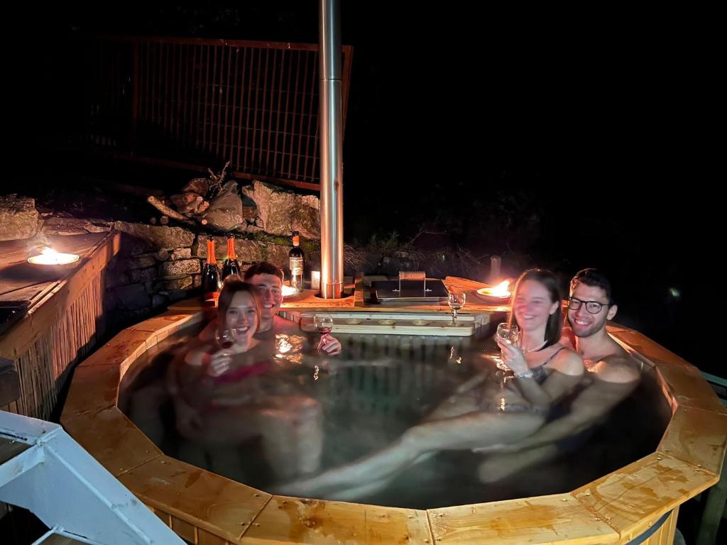 a group of people in a swimming pool at night at La Casa sulla collina del Castello in Breno