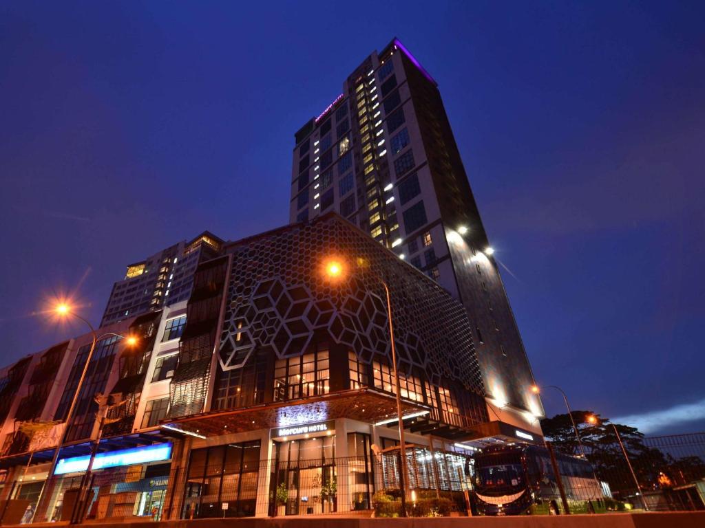 a tall building with lights in front of it at Mercure Selangor Selayang in Batu Caves