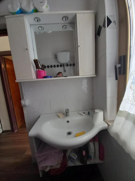 a bathroom with a white sink and a mirror at Casa tiziana in Terracina