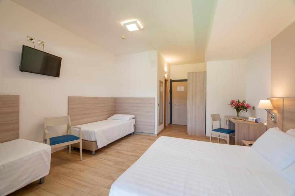 Een bed of bedden in een kamer bij Hotel Portoconte