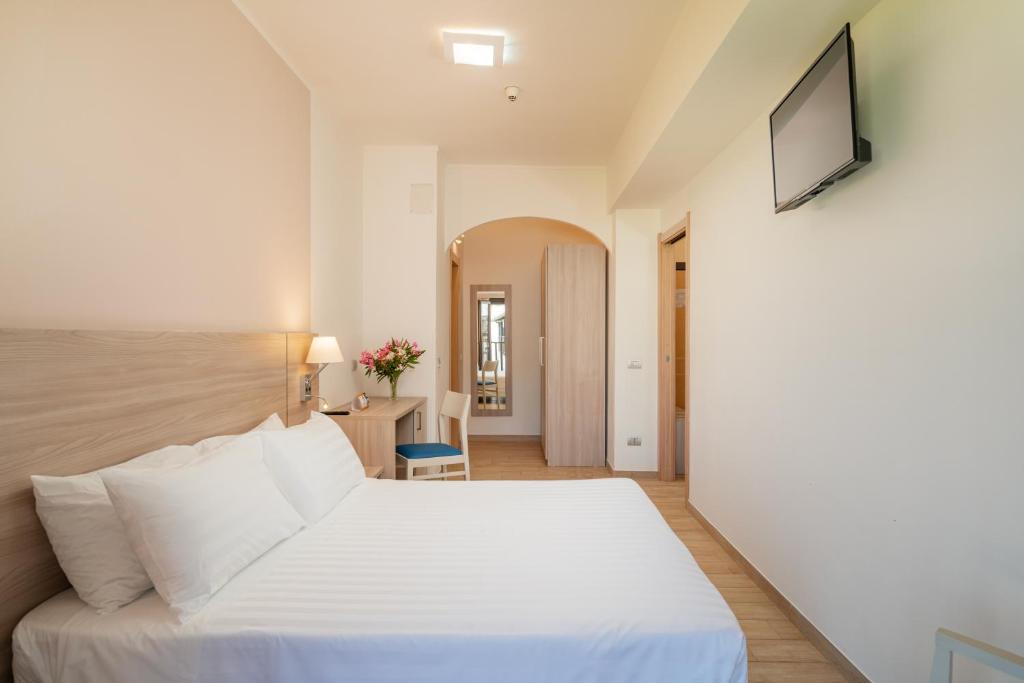 Een bed of bedden in een kamer bij Hotel Portoconte
