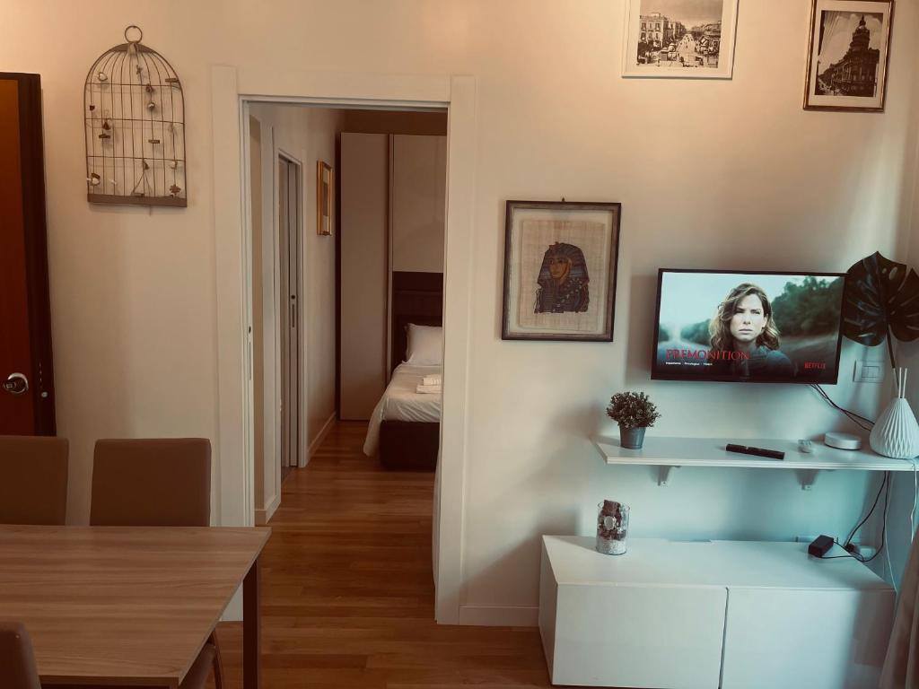 a living room with a tv on a wall at Futura Exclusive Suite 4 in Bari