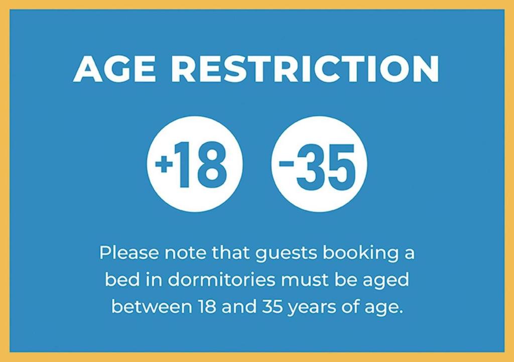 a sign that says age restriction and a bed in donutions must be aged at Central Station B&B Naples in Naples