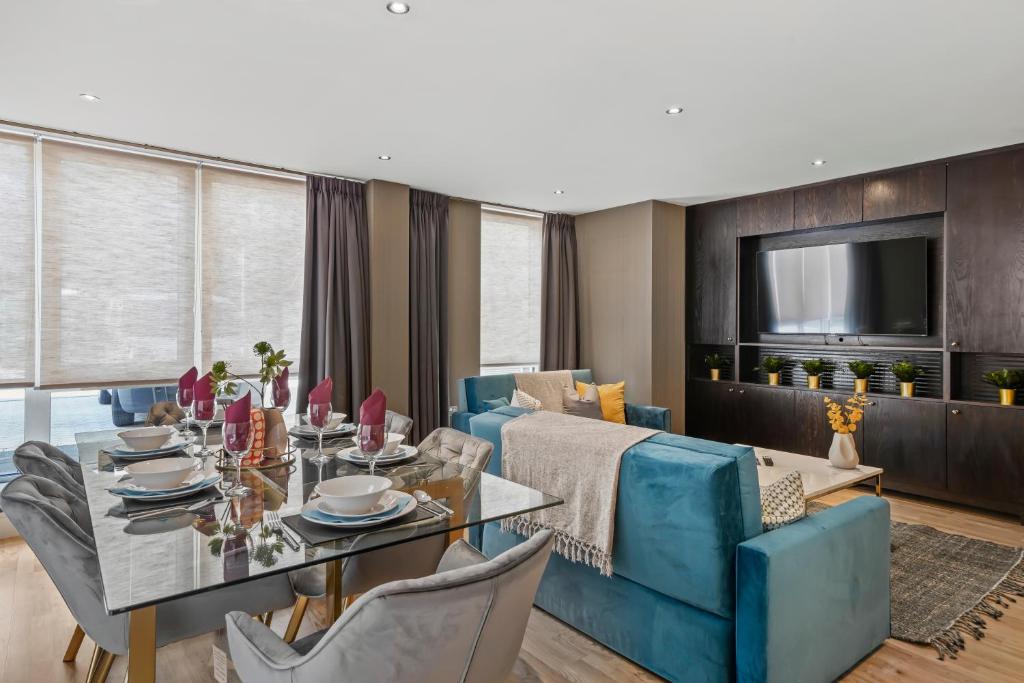 a living room with a dining table and a couch at Beautiful Duplex - Sleeps 10 in London