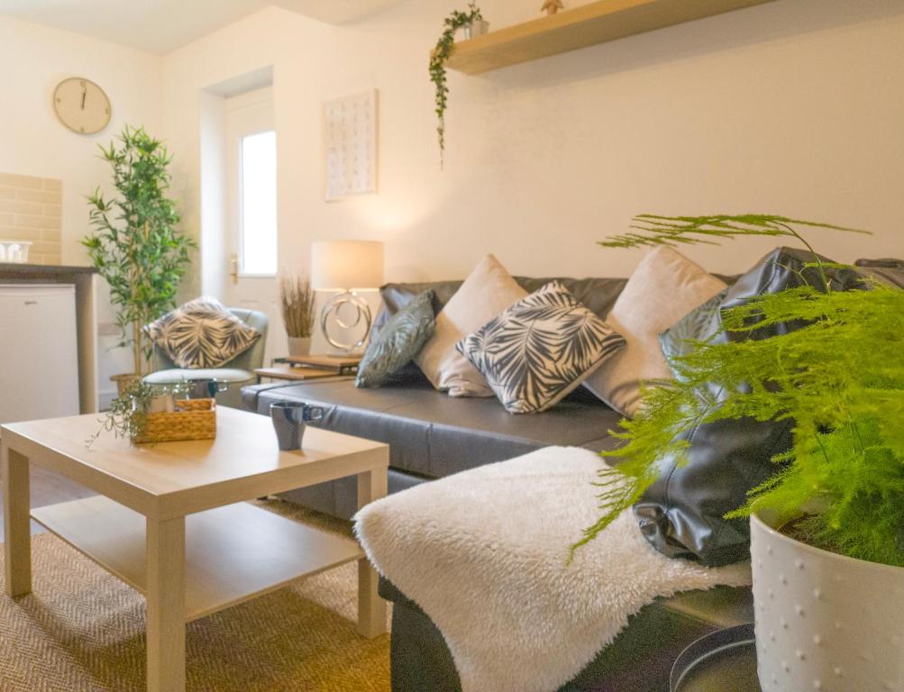a living room with a couch with pillows on it at Principality Suites - Two Bed Apartment by Property Promise in Cardiff