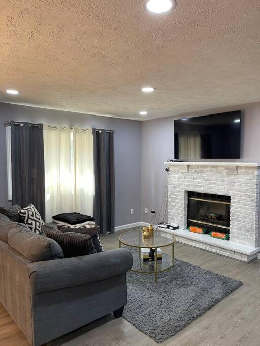 a living room with a couch and a fireplace at The Tranquility in Tobyhanna
