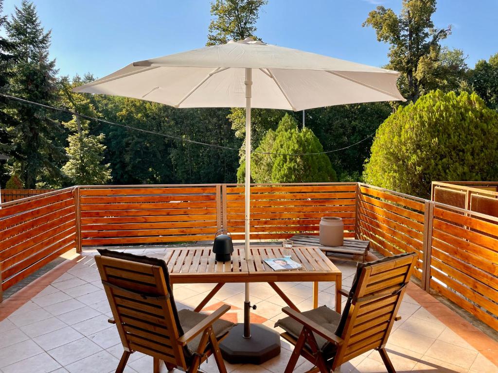 a table with an umbrella on a patio at Felix Villa in Nyíregyháza