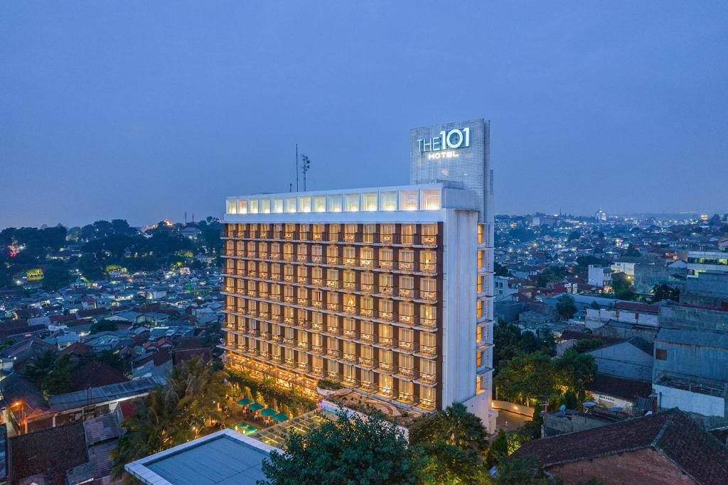 a lit up building in a city at night at THE 1O1 Bogor Suryakancana in Bogor