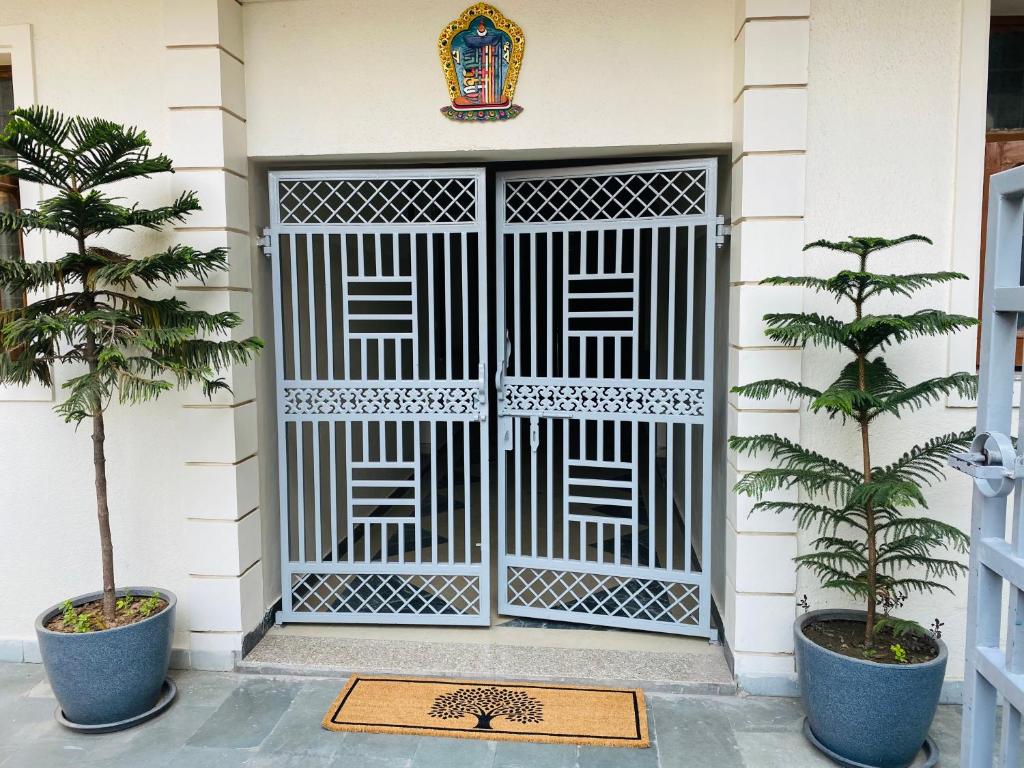 a front door of a house with a gate at Negi Lodge Chandigarh in Chandīgarh