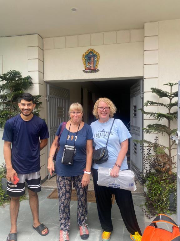 a group of three people standing in front of a building at Negi Lodge Chandigarh in Chandīgarh