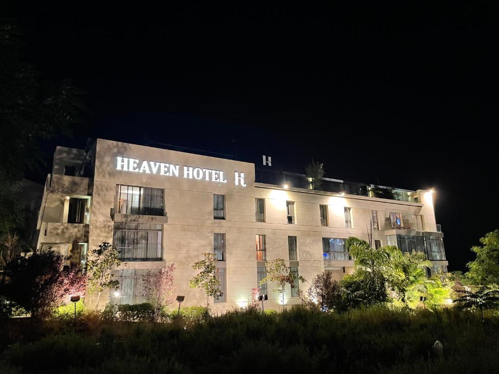 a building with a sign that says healer hotel at night at Heaven Prestige Hotel in Jounieh