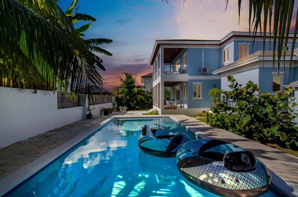 a swimming pool in the backyard of a house at Blu Diamond Luxury Estate in Nassau