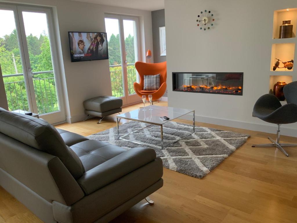a living room with a couch and a fireplace at Parkview, St Andrews in St. Andrews