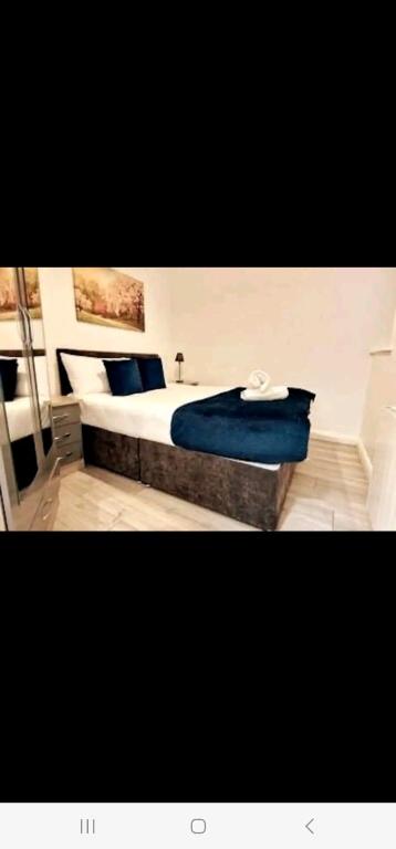 a bedroom with a bed with blue sheets and pillows at Liffey Suites in Dublin