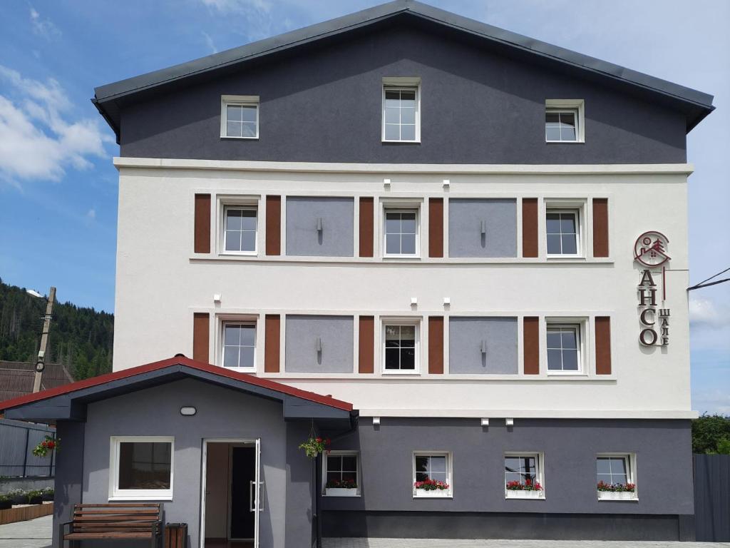 a large white building with windows at Шале АНСО in Mykulychyn